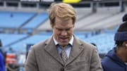 Dec 15, 2024; Charlotte, North Carolina, USA; Former Panther and broadcaster Greg Olsen signs an autograph for a fan during pregame warmups between the Carolina Panthers and the Dallas Cowboys at Bank of America Stadium.