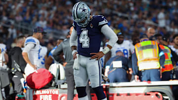 Oct 13, 2024; Arlington, Texas, USA;  Dallas Cowboys quarterback Dak Prescott (4) says a prayer for Detroit Lions injured defensive end Aidan Hutchinson (97) during the second half at AT&T Stadium. Mandatory Credit: Kevin Jairaj-Imagn Images