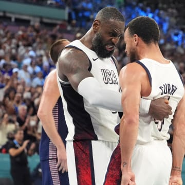 Aug 8, 2024; Paris, France; United States forward LeBron James (6) and guard Stephen Curry (4) celebrate after the game against Serbia  in a men's basketball semifinal game during the Paris 2024 Olympic Summer Games at Accor Arena. 