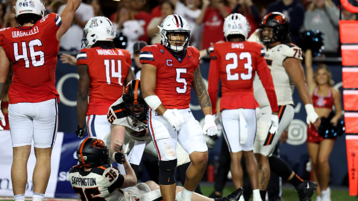 Oct 28, 2023; Tucson, Arizona, USA; Arizona Wildcats linebacker Jacob Manu #5 celebrates a tackle agaisnt Oregon State Beavers place kicker Atticus Sappington #36 during the first half at Arizona Stadium. Mandatory Credit: Zachary BonDurant-USA TODAY Sports