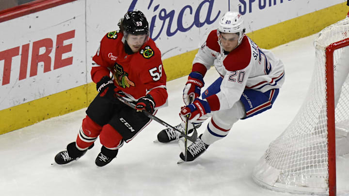 Jan 3, 2025; Chicago, Illinois, USA;  Chicago Blackhawks left wing Tyler Bertuzzi (59) moves the puck against Montreal Canadiens left wing Juraj Slafkovsky (20) during the second period at United Center. Mandatory Credit: Matt Marton-Imagn Images