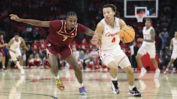 Dec 5, 2025; Houston, Texas, USA; Houston Cougars guard Kingston Flemings (4) controls the ball as Florida State Seminoles forward Chauncey Wiggins (7) defends during the first half at Toyota Center. 