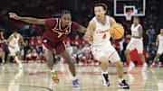 Houston Cougars guard Kingston Flemings (4) controls the ball as Florida State Seminoles forward Chauncey Wiggins (7) defends during the first half at Toyota Center.