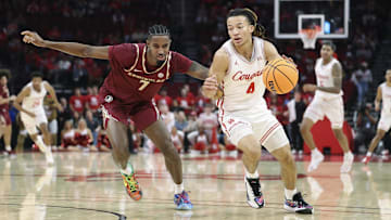 Houston Cougars guard Kingston Flemings (4) controls the ball as Florida State Seminoles forward Chauncey Wiggins (7) defends during the first half at Toyota Center.