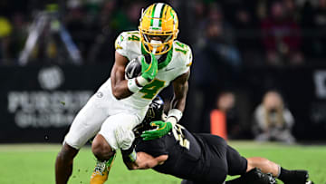 Oct 18, 2024; West Lafayette, Indiana, USA; Oregon Ducks wide receiver Justius Lowe (14) is tackled by Purdue Boilermakers linebacker Yanni Karlaftis (14) during the second half at Ross-Ade Stadium. Mandatory Credit: Marc Lebryk-Imagn Images