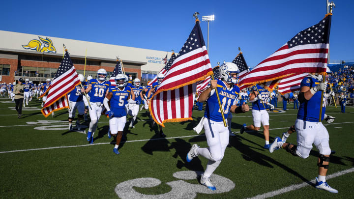 South Dakota State runs onto the field with U.S. flags before the game against Missouri State