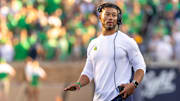 Oct 4, 2025; South Bend, Indiana, USA; Notre Dame head football coach Marcus Freeman adjusts his radio against the Boise State Broncos at Notre Dame Stadium.