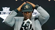 Jul 9, 2025; Frisco, TX, USA; Colorado head coach Deion Sanders fixes his cap prior to speaking with the media during 2025 Big 12 Football Media Days at The Star. Mandatory Credit: Raymond Carlin III-Imagn Images