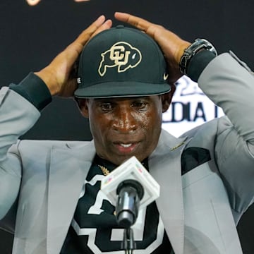 Jul 9, 2025; Frisco, TX, USA; Colorado head coach Deion Sanders fixes his cap prior to speaking with the media during 2025 Big 12 Football Media Days at The Star. Mandatory Credit: Raymond Carlin III-Imagn Images