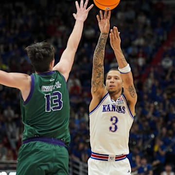 Nov 3, 2025; Lawrence, Kansas, USA; Kansas Jayhawks guard Tre White (3) shoots against Green Bay Phoenix forward Marcus Hall (13) during the second half at Allen Fieldhouse. Mandatory Credit: Jay Biggerstaff-Imagn Images