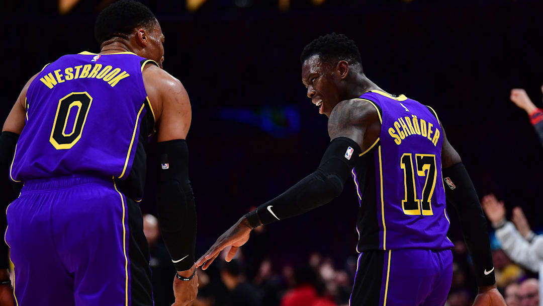 Dec 16, 2022; Los Angeles, California, USA; Los Angeles Lakers guard Dennis Schroder (17) celebrates his three point basket scored against the Denver Nuggets with guard Russell Westbrook (0) during the second half at Crypto.com Arena. Mandatory Credit: Gary A. Vasquez-Imagn Images