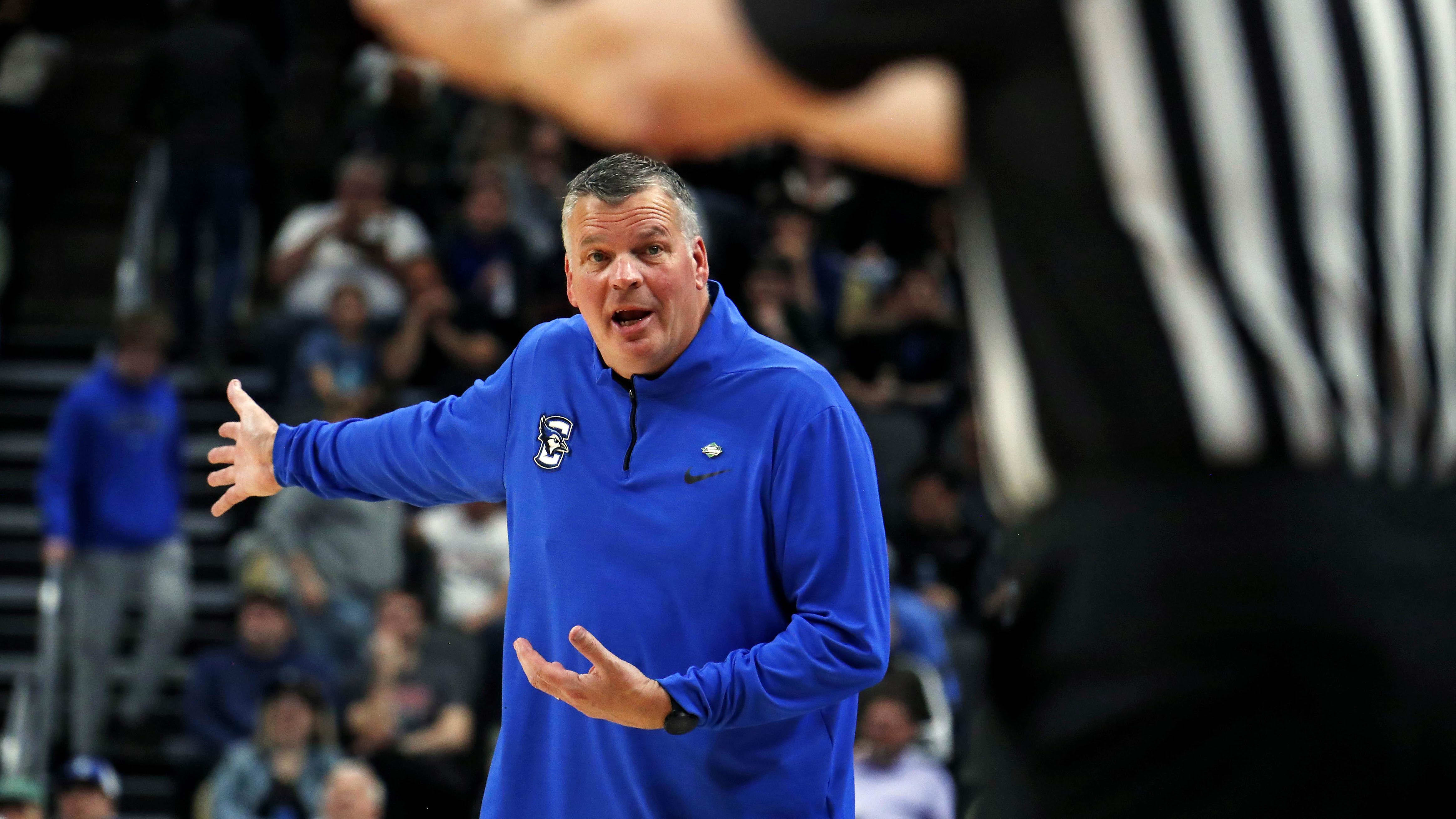 Creighton Bluejays head coach Greg McDermott talks to a referee.