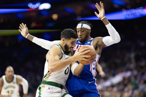 Boston Celtics forward Jayson Tatum (0) drives against Philadelphia 76ers forward Robert Covington (33).