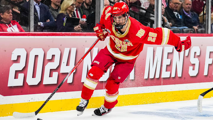 Apr 11, 2024; Saint Paul, Minnesota, USA; Denver defenseman Zeev Buium (28) carries the puck in the semifinals of the 2024 Frozen Four college ice hockey tournament during the first period against Boston U at Xcel Energy Center. Mandatory Credit: Brace Hemmelgarn-Imagn Images