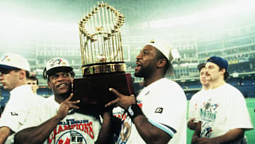 Blue Jays outfielders Rickey Henderson and Joe Carter celebrate the team's victory following Game 6 of the 1993 World Series against the Philadelphia Phillies.