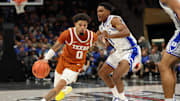 Texas Longhorns guard Jordan Pope (0) drives the ball around Duke Blue Devils guard Caleb Foster (1).