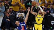 May 27, 2025; Indianapolis, Indiana, USA; Indiana Pacers guard Tyrese Haliburton (0) shoots a three-point basket over New York Knicks guard Jalen Brunson (11) during the fourth quarter of game four of the Eastern Conference Finals for the 2025 NBA Playoffs at Gainbridge Fieldhouse. Mandatory Credit: Trevor Ruszkowski-Imagn Images