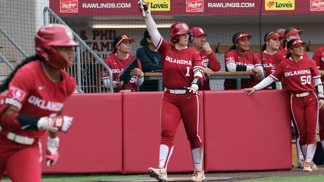 Oklahoma catcher Kendall Wells celebrates a hit from outfielder Kai Minor at Love's Field.