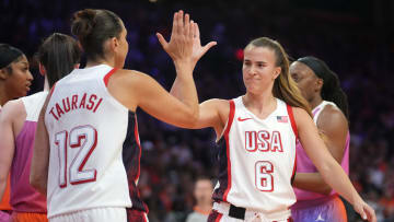 Team USA guard Sabrina Ionescu (6) high-fives teammate Diana Taurasi.