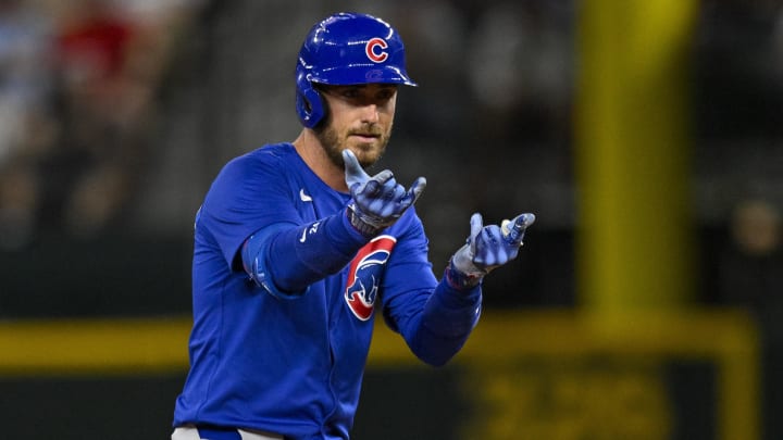 Mar 28, 2024; Arlington, Texas, USA; Chicago Cubs center fielder Cody Bellinger (24) celebrates at second base after he hits a double and drives in a run against the Texas Rangers during the sixth inning at Globe Life Field.