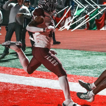 Lawrence North Wildcats wide receiver Davion Chandler (8) scores a touchdown against Lawrence Central on Friday, Oct. 27, 2023.