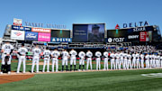 New York Yankees players stand for a moment of silence to honor the memory of Miller Gardner, son of Yankees former player Brett Gardner.