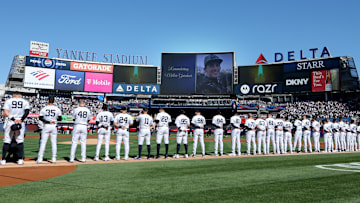 New York Yankees players stand for a moment of silence to honor the memory of Miller Gardner, son of Yankees former player Brett Gardner.