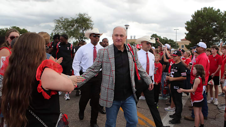 Aug 30, 2025; Lubbock, Texas, USA;  Texas Tech Red Raiders head coach Joey McGuire greets fans during the Raiders Walk before the game against the Arkansas-Pine Bluff Golden Lions at Jones AT&T Stadium. Mandatory Credit: Michael C. Johnson-Imagn Images