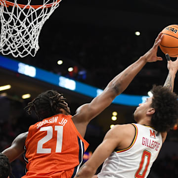 Mar 14, 2025; Indianapolis, IN, USA; Illinois Fighting Illini forward Morez Johnson Jr. (21) blocks Maryland Terrapins guard Ja'Kobi Gillespie (0) during the first half at Gainbridge Fieldhouse. Mandatory Credit: Robert Goddin-Imagn Images