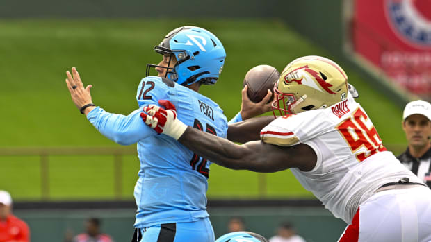 Mar 30, 2024; Arlington, TX, USA; Birmingham Stallions defensive lineman Carlos Davis (96) forces a fumble by Arlington Renegades quarterback Luis Perez (12) during the first half at Choctaw Stadium. Mandatory Credit: Jerome Miron-USA TODAY Sports