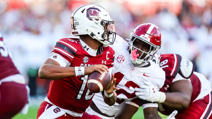Oct 25, 2025; Columbia, South Carolina, USA; South Carolina Gamecocks quarterback Lanorris Sellers (16) looks to pass under pressure from Alabama Crimson Tide linebacker Yhonzae Pierre (42) in the second quarter at Williams-Brice Stadium. Mandatory Credit: Jeff Blake-Imagn Images