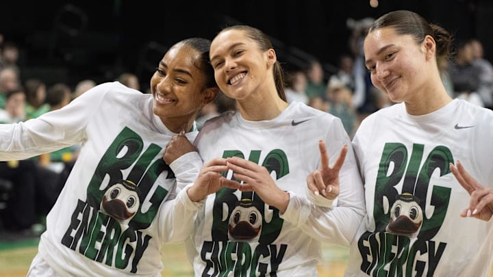 Oregon’s Deja Kelly, Peyton Scott, and Nani Falatea join the team on the court before their game against Rutgers at Matthew Knight Arena.