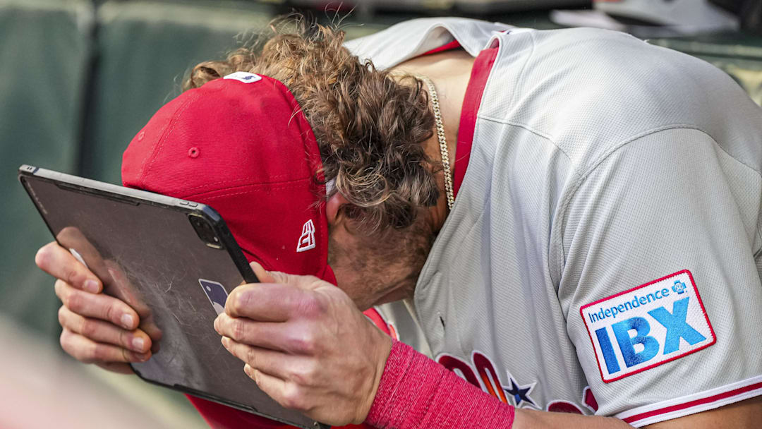 Apr 9, 2025; Cumberland, Georgia, USA; Philadelphia Phillies third base Alec Bohm (28) reacts in the dugout against the Atlanta Braves during the second inning at Truist Park.