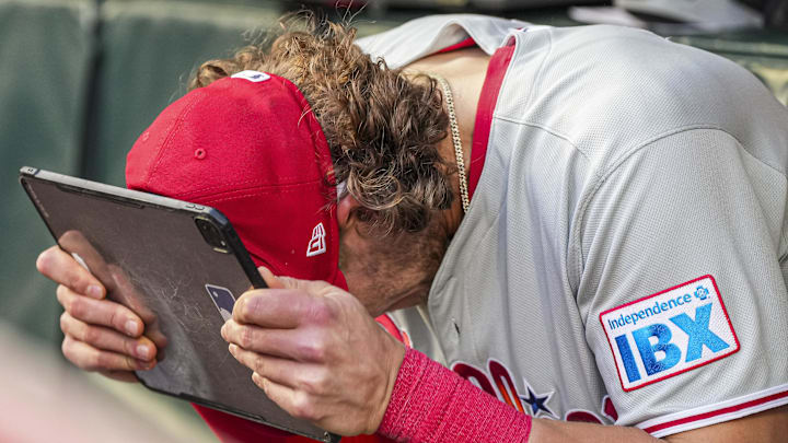 Apr 9, 2025; Cumberland, Georgia, USA; Philadelphia Phillies third base Alec Bohm (28) reacts in the dugout against the Atlanta Braves during the second inning at Truist Park. Mandatory Credit: Dale Zanine-Imagn Images