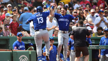 Jul 14, 2024; Boston, Massachusetts, USA;  Kansas City Royals designated hitter Salvador Perez (13) reacts with shortstop Bobby Witt Jr. (7) after hitting a home run during the sixth inning against the Boston Red Sox at Fenway Park. Mandatory Credit: Bob DeChiara-USA TODAY Sports