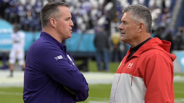 Dec 31, 2018; San Diego, CA, United States; Northwestern Wildcats head coach Pat Fitzgerald (left) and Utah Utes head coach Kyle Whittingham talk during the 2018 Holiday Bowl at SDCCU Stadium. Mandatory Credit: Kirby Lee-Imagn Images