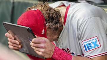 Apr 9, 2025; Cumberland, Georgia, USA; Philadelphia Phillies third base Alec Bohm (28) reacts in the dugout against the Atlanta Braves during the second inning at Truist Park. Mandatory Credit: Dale Zanine-Imagn Images