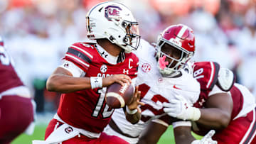 Oct 25, 2025; Columbia, South Carolina, USA; South Carolina Gamecocks quarterback Lanorris Sellers (16) looks to pass under pressure from Alabama Crimson Tide linebacker Yhonzae Pierre (42) in the second quarter at Williams-Brice Stadium. Mandatory Credit: Jeff Blake-Imagn Images
