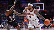 Nov 11, 2025; Champaign, Illinois, USA;  Illinois Fighting Illini guard Kylan Boswell (4) drives the ball past Texas Tech Red Raiders guard Jaylen Petty (11) during the first half at State Farm Center. Mandatory Credit: Ron Johnson-Imagn Images