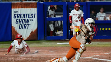 Texas Tech utility Makayla Garcia (3) watches Texas catcher Reese Atwood (14) after Garcia scored in Game 2 of the Women's College World Series championship series between the Texas Longhorns at Texas Tech Red Raiders at Devon Park in Oklahoma City, Thursday, June 5, 2025. Texas Tech won 4-3.