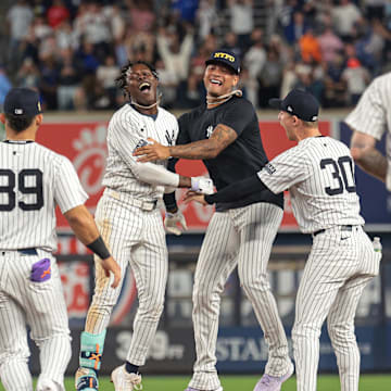 Sep 11, 2024; Bronx, New York, USA; New York Yankees third baseman Jazz Chisholm Jr. (13) celebrates with starting pitcher Luis Gil (81) and teammates after hitting a game winning RBI single during the eleventh inning against the Kansas City Royals at Yankee Stadium. Mandatory Credit: Vincent Carchietta-Imagn Images