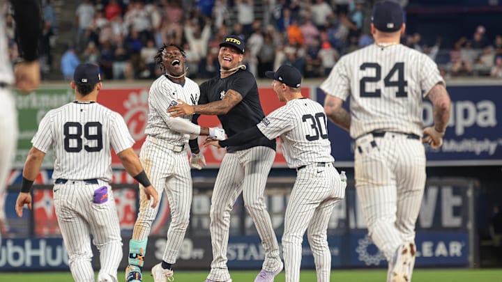 Sep 11, 2024; Bronx, New York, USA; New York Yankees third baseman Jazz Chisholm Jr. (13) celebrates with starting pitcher Luis Gil (81) and teammates after hitting a game winning RBI single during the eleventh inning against the Kansas City Royals at Yankee Stadium. Mandatory Credit: Vincent Carchietta-Imagn Images