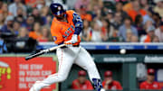 May 9, 2025; Houston, Texas, USA; Houston Astros first baseman Christian Walker (8) hits a single against the Cincinnati Reds during the fourth inning at Daikin Park.