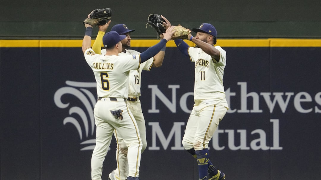 Sep 18, 2025; Milwaukee, Wisconsin, USA; Milwaukee Brewers outfielder Isaac Collins (6) Milwaukee Brewers outfielder Blake Perkins (16) and Milwaukee Brewers outfielder Jackson Chourio (11) celebrate a 5-2 win over the Los Angeles Angels  at American Family Field. Mandatory Credit: Michael McLoone-Imagn Images