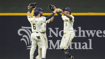 Sep 18, 2025; Milwaukee, Wisconsin, USA; Milwaukee Brewers outfielder Isaac Collins (6) Milwaukee Brewers outfielder Blake Perkins (16) and Milwaukee Brewers outfielder Jackson Chourio (11) celebrate a 5-2 win over the Los Angeles Angels  at American Family Field. Mandatory Credit: Michael McLoone-Imagn Images