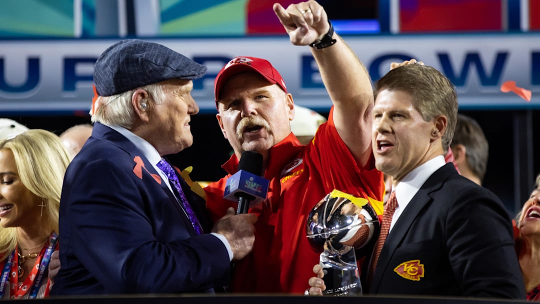 Feb 12, 2023; Glendale, Arizona, US; Fox host Terry Bradshaw (left) interviews Kansas City Chiefs head coach Andy Reid (center) as he celebrates with team owner Clark Hunt and the Vince Lombardi Trophy after winning Super Bowl LVII against the Philadelphia Eagles at State Farm Stadium. Mandatory Credit: Mark J. Rebilas-Imagn Images