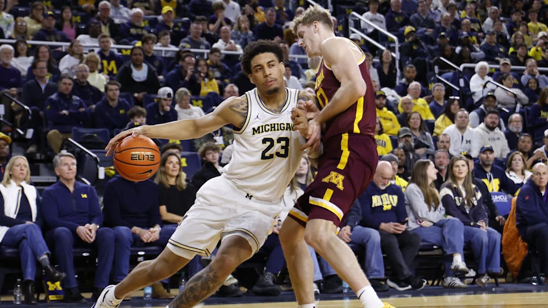 Michigan Wolverines forward Yaxel Lendeborg is defended by Minnesota Golden Gophers guard Cade Tyson