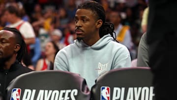 Apr 26, 2025; Memphis, Tennessee, USA; Memphis Grizzlies guard Ja Morant (12) looks on from the bench area during the fourth quarter against the Oklahoma City Thunder during game four for the first round of the 2024 NBA Playoffs at FedExForum. Mandatory Credit: Petre Thomas-Imagn Images