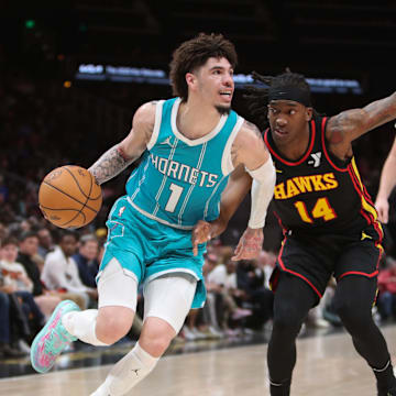 Mar 12, 2025; Atlanta, Georgia, USA; Charlotte Hornets guard LaMelo Ball (1) works past Atlanta Hawks guard Terance Mann (14) during the second half at State Farm Arena. Mandatory Credit: Mady Mertens-Imagn Images