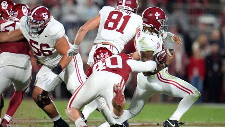Oklahoma Sooners defensive lineman Bergin Kysar (80) brings down Alabama Crimson Tide quarterback Jalen Milroe (4) during a college football game between the University of Oklahoma Sooners (OU) and the Alabama Crimson Tide at Gaylord Family - Oklahoma Memorial Stadium in Norman, Okla., Saturday, Nov. 23, 2024.
